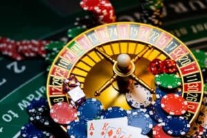 A roulette wheel with cards and chips on it.