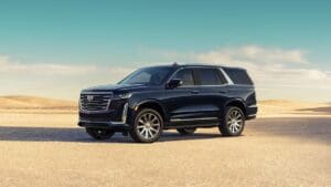 A black suv is parked on the side of a road.