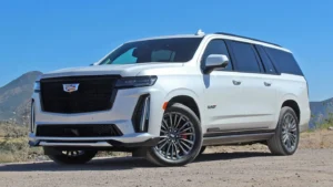 A white suv parked on top of a dirt road.