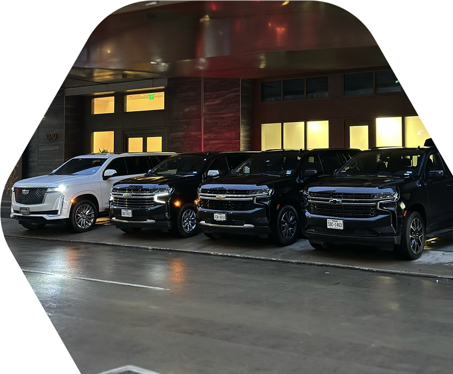 A row of black and white cars parked in front of a building.